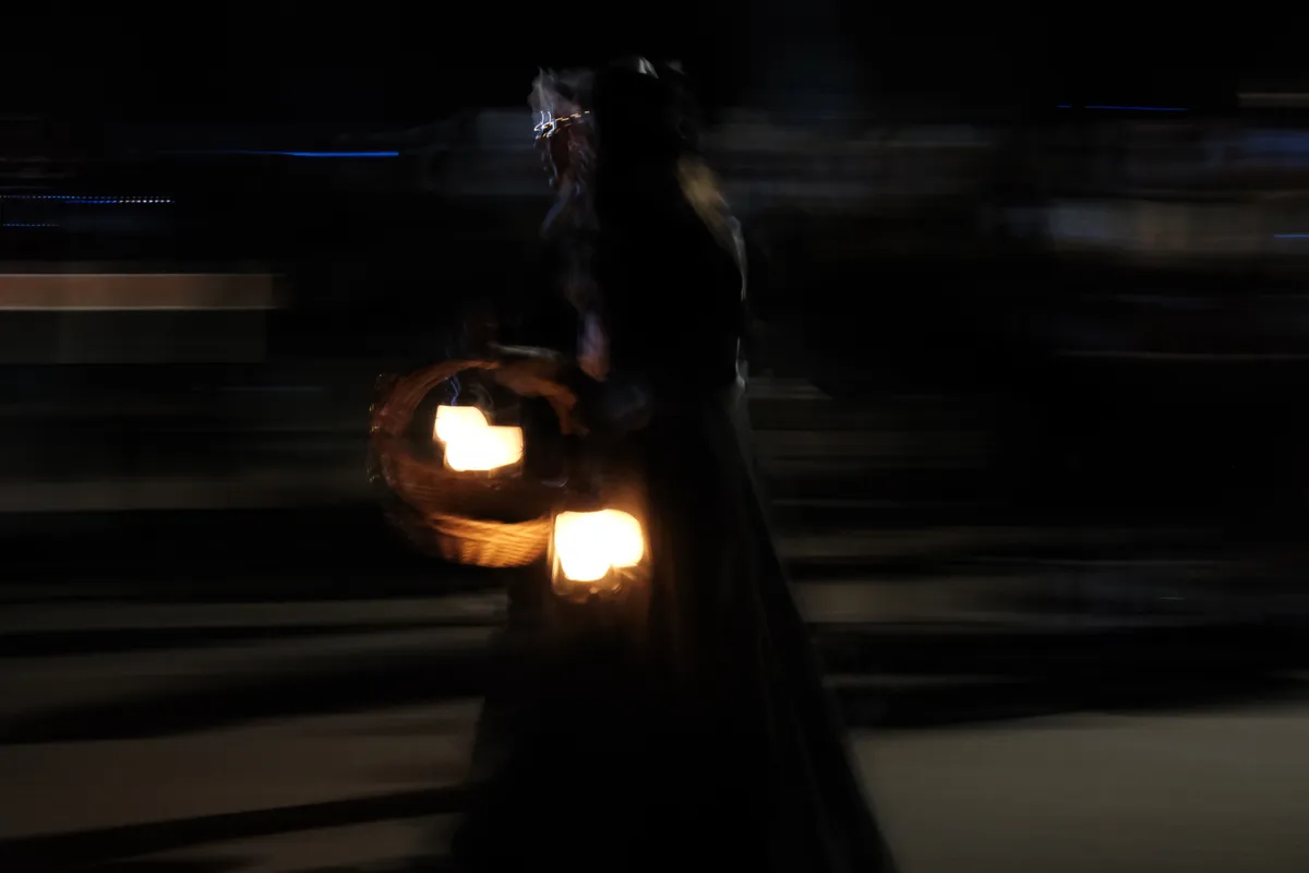 blurry image of walkers with lantern